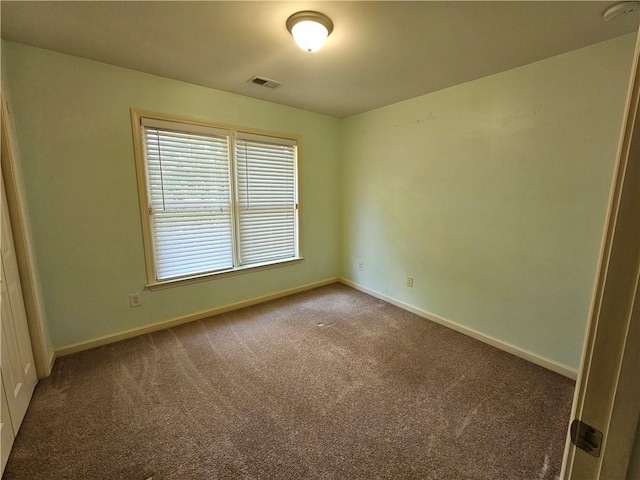 carpeted empty room with baseboards and visible vents