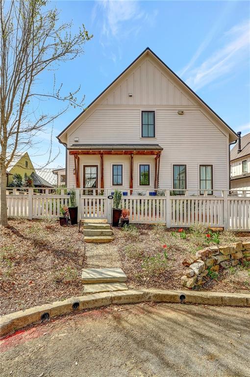 150 Ray Way, Chattahoochee Hills, GA 30268 - view of front of home featuring covered porch, board and batten siding, and a fenced front yard