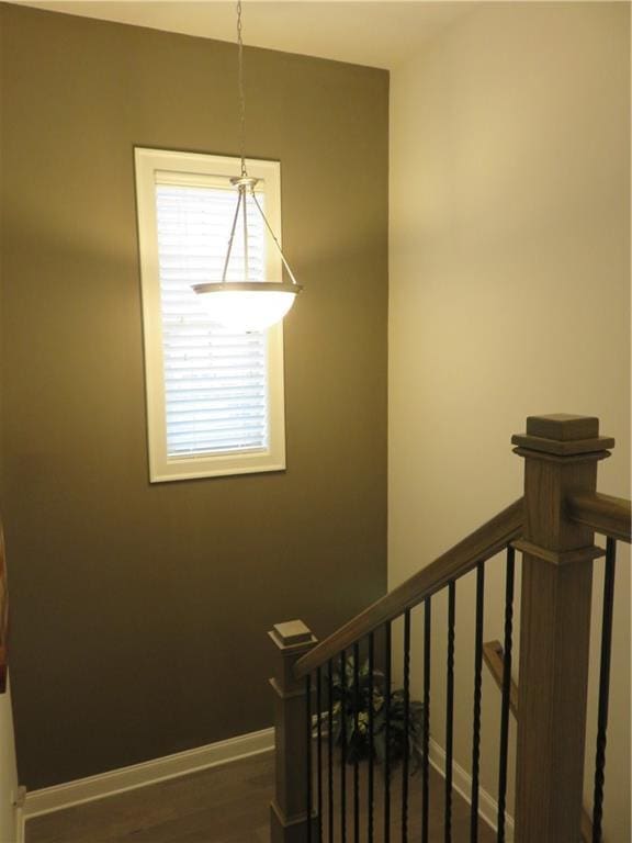 stairs featuring hardwood / wood-style floors