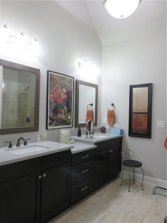 bathroom featuring vaulted ceiling, vanity, and an enclosed shower