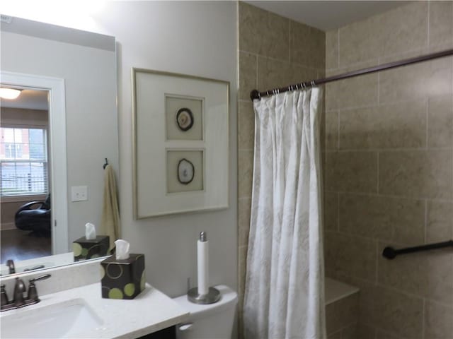 bathroom featuring vanity, toilet, and curtained shower