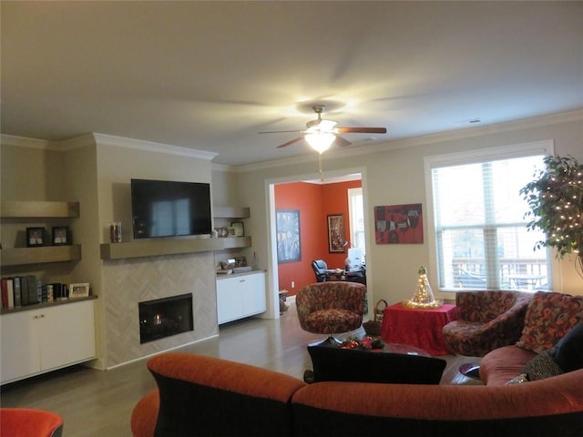 living room featuring ceiling fan, wood-type flooring, and crown molding