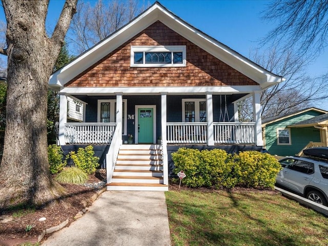 bungalow-style house featuring a porch and stairs