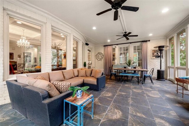 living room with recessed lighting, ornamental molding, and ceiling fan with notable chandelier