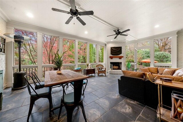sunroom / solarium featuring crown molding, recessed lighting, and stone tile flooring