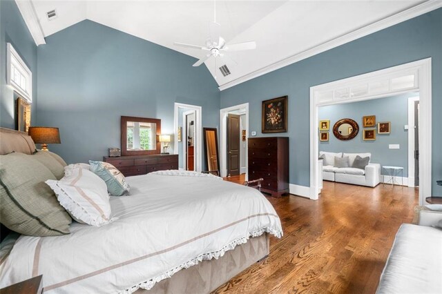 bedroom with visible vents, wood finished floors, baseboards, a ceiling fan, and vaulted ceiling