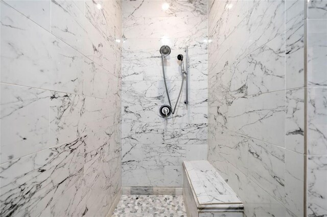 bathroom with a marble finish shower