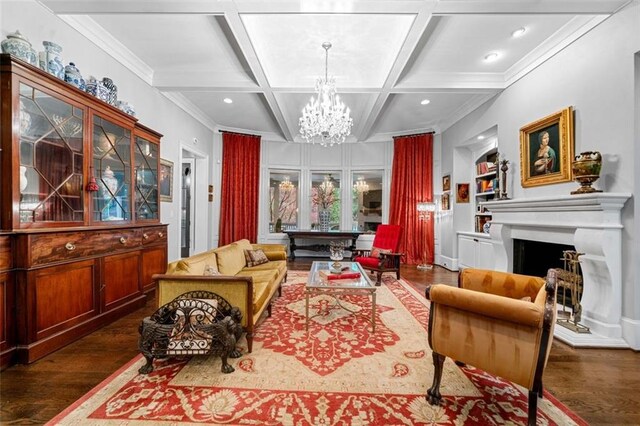 living area featuring dark wood-type flooring, coffered ceiling, beam ceiling, and a chandelier