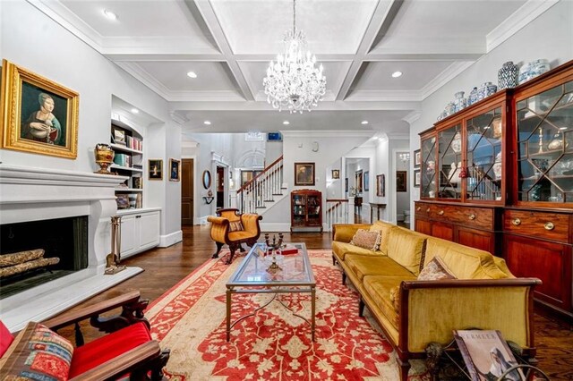 living room with an inviting chandelier, stairs, beam ceiling, and coffered ceiling