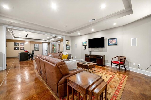 living room with visible vents, recessed lighting, and a tray ceiling