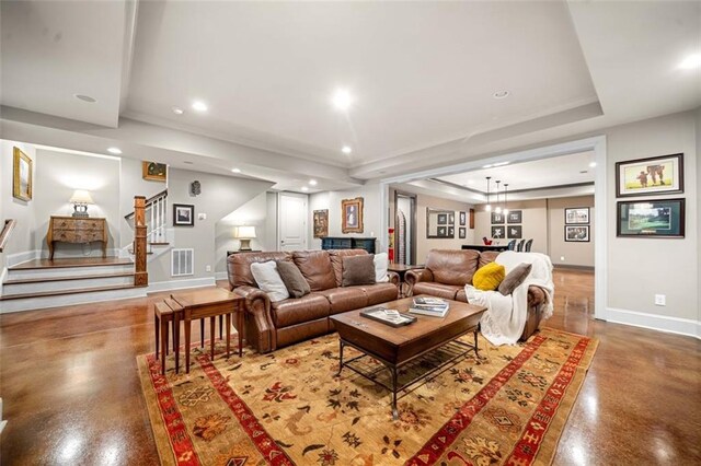 living room with visible vents, baseboards, stairway, recessed lighting, and a tray ceiling