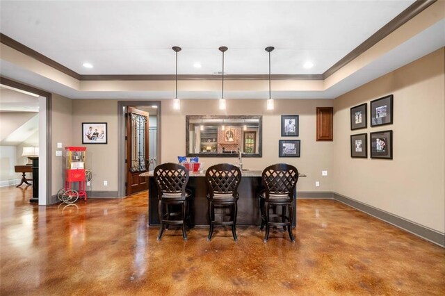 bar with baseboards, concrete floors, and a raised ceiling