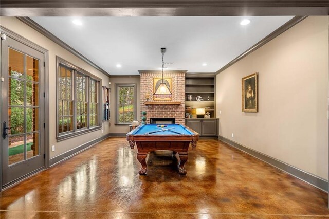 playroom with crown molding, built in features, a fireplace, concrete flooring, and baseboards