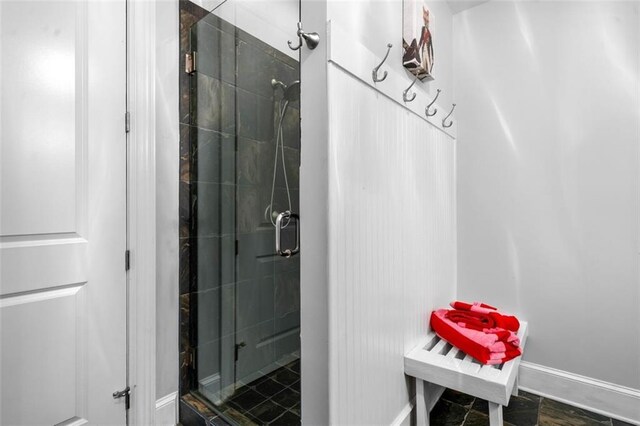 full bathroom with baseboards and a stall shower