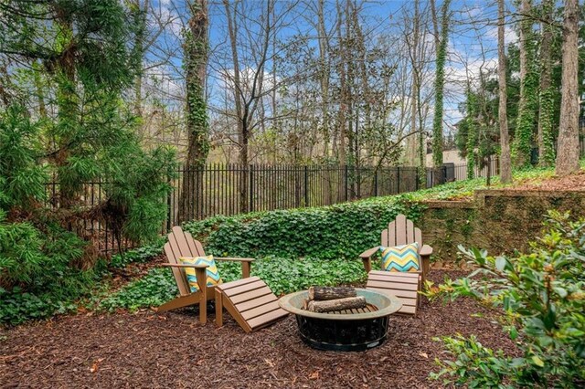 view of yard featuring fence and an outdoor fire pit
