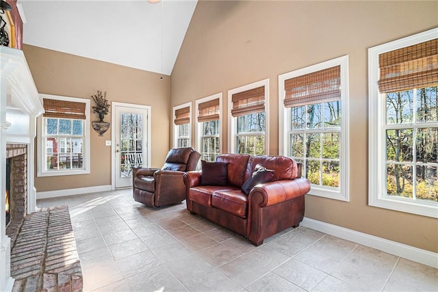 sunroom / solarium with a fireplace and lofted ceiling