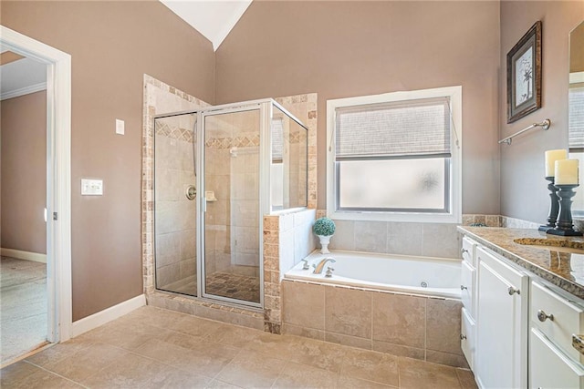 full bathroom with vanity, lofted ceiling, tile patterned flooring, a shower stall, and a garden tub