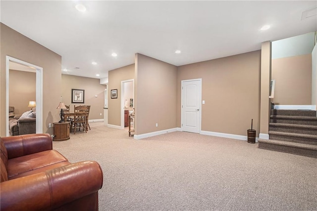 living room with recessed lighting, stairway, baseboards, and light colored carpet