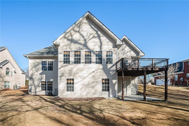 back of property featuring a yard, a patio, and a wooden deck