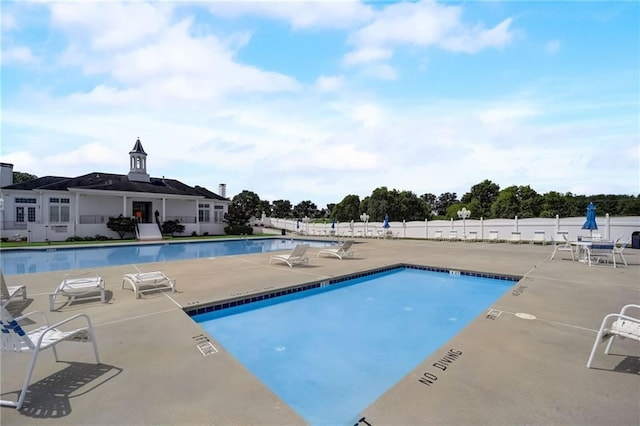 pool featuring a patio area and fence