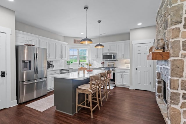 300 Olde Wick Trl, Hoschton, GA 30548 - kitchen with appliances with stainless steel finishes, white cabinets, light countertops, decorative backsplash, and recessed lighting
