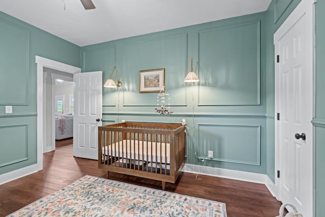 300 Olde Wick Trl, Hoschton, GA 30548 - bedroom featuring a decorative wall, wood finished floors, and a nursery area