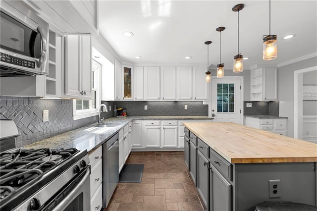 75 Auburn Rd, Auburn, GA 30011 - kitchen with appliances with stainless steel finishes, a sink, butcher block countertops, dark stone finish floors, and white cabinets