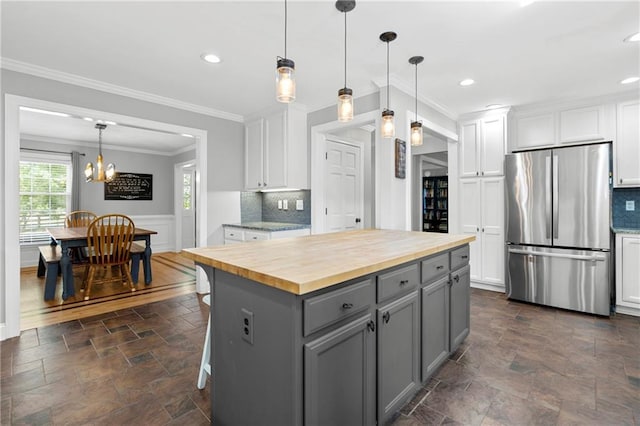 75 Auburn Rd, Auburn, GA 30011 - kitchen featuring freestanding refrigerator, butcher block countertops, gray cabinets, dark stone finish flooring, and ornamental molding