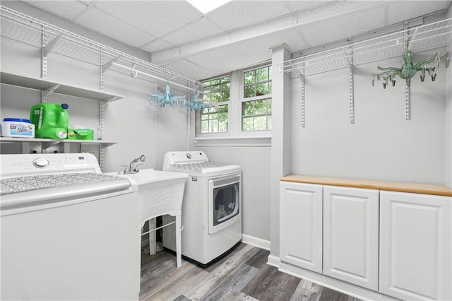 75 Auburn Rd, Auburn, GA 30011 - laundry room with washing machine and dryer, wood finished floors, baseboards, and cabinet space