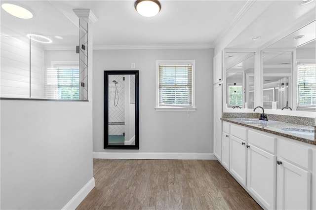 75 Auburn Rd, Auburn, GA 30011 - bathroom with baseboards, wood finished floors, double vanity, and crown molding