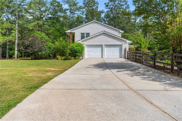75 Auburn Rd, Auburn, GA 30011 - view of front of house featuring driveway, view of scattered trees, and a garage