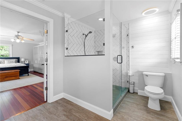 75 Auburn Rd, Auburn, GA 30011 - bathroom featuring wood finished floors, crown molding, a shower stall, toilet, and baseboards