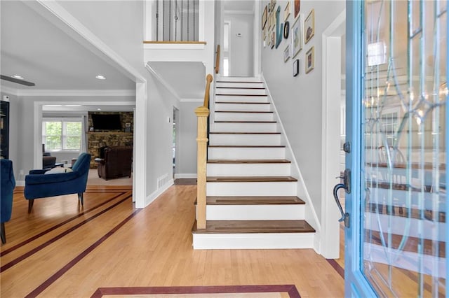 75 Auburn Rd, Auburn, GA 30011 - foyer entrance featuring crown molding, wood finished floors, stairway, a fireplace, and baseboards