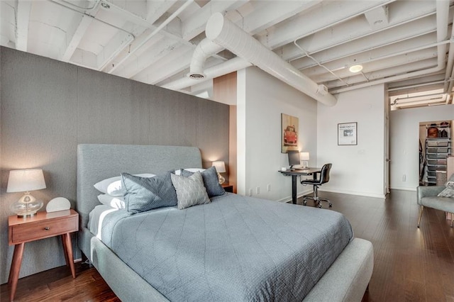 bedroom with dark wood-type flooring