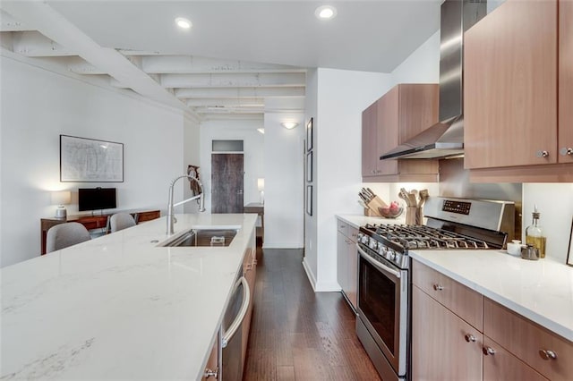 kitchen with sink, appliances with stainless steel finishes, light stone countertops, dark hardwood / wood-style flooring, and wall chimney exhaust hood