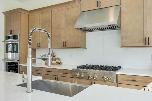 kitchen featuring appliances with stainless steel finishes, sink, and backsplash