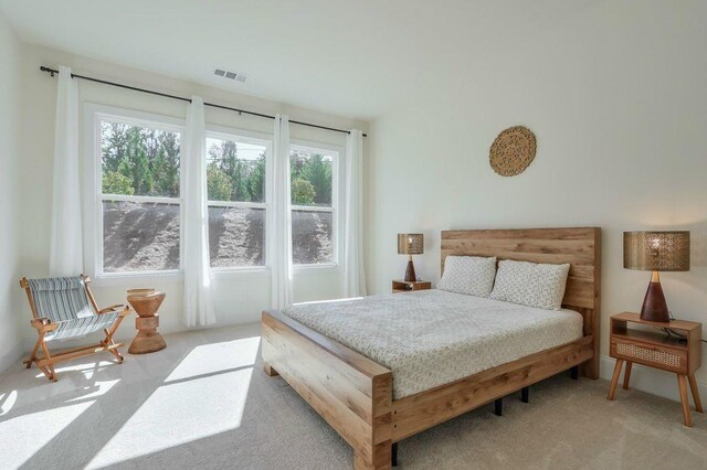 bedroom featuring light colored carpet