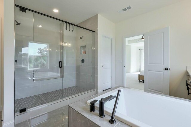 bathroom with shower with separate bathtub