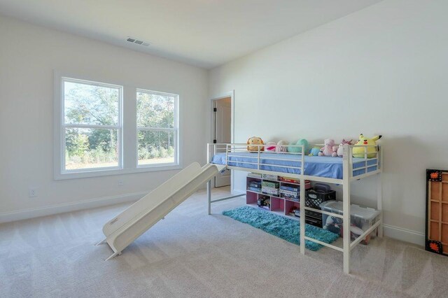 bedroom featuring light colored carpet