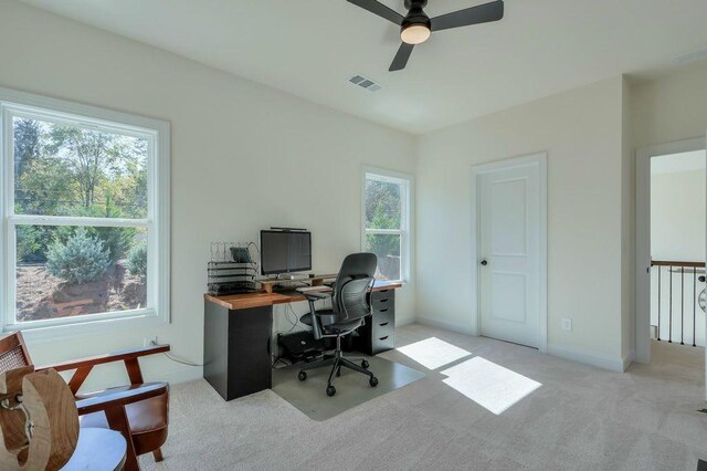 carpeted home office featuring ceiling fan and a healthy amount of sunlight