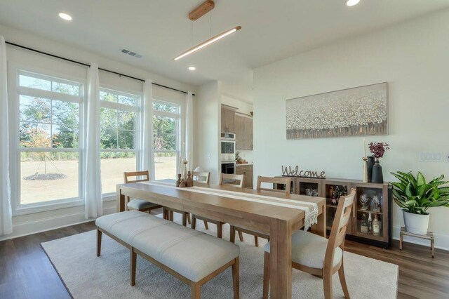 dining space with dark wood-type flooring