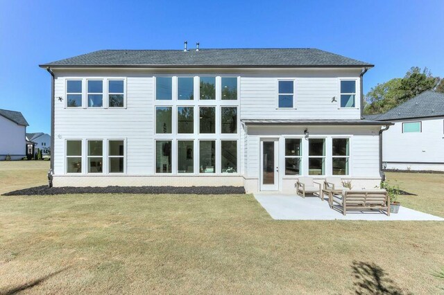 rear view of house with a patio, a yard, and an outdoor hangout area