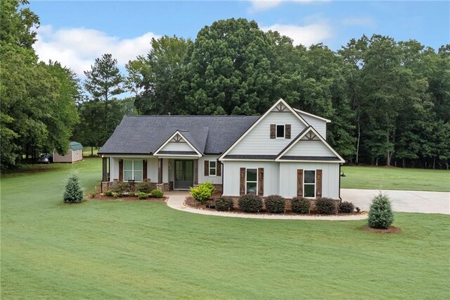 340 Taylor Path, Dallas, GA 30157 - view of front of property with concrete driveway, a front yard, board and batten siding, roof with shingles, and french doors