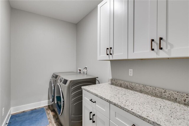340 Taylor Path, Dallas, GA 30157 - laundry room featuring baseboards, washing machine and dryer, wood finished floors, and cabinet space