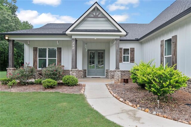 340 Taylor Path, Dallas, GA 30157 - view of exterior entry with french doors, board and batten siding, brick siding, and roof with shingles