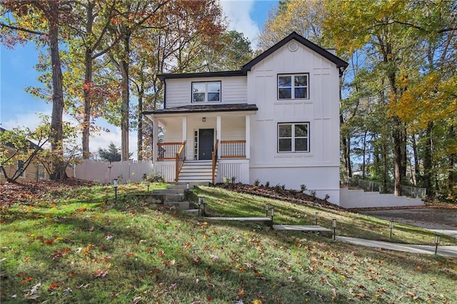 view of front of home featuring a front lawn and covered porch