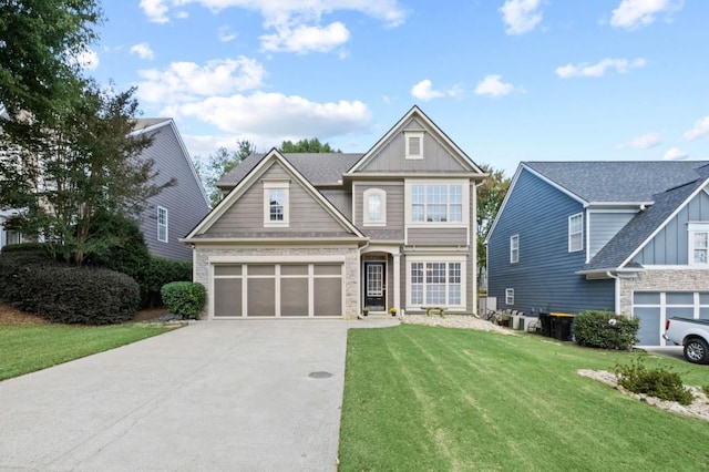 craftsman inspired home featuring a garage and a front lawn