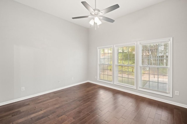 spare room featuring dark hardwood / wood-style flooring and ceiling fan