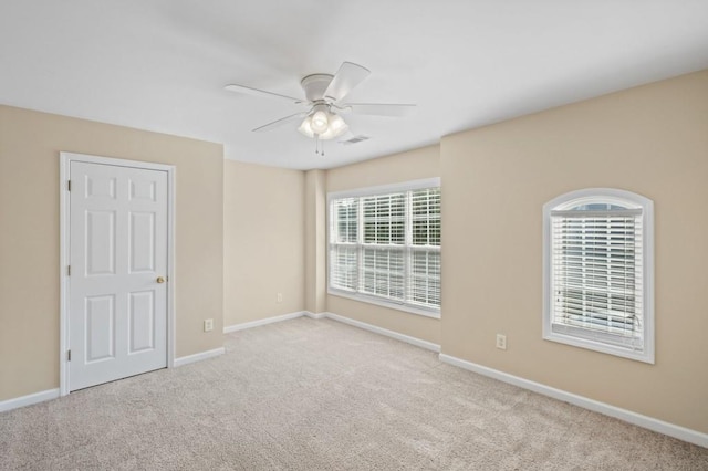 carpeted empty room featuring ceiling fan