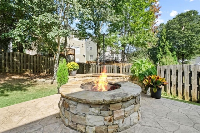 view of patio / terrace featuring an outdoor fire pit